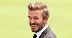 David Beckham in a suit on the pitch