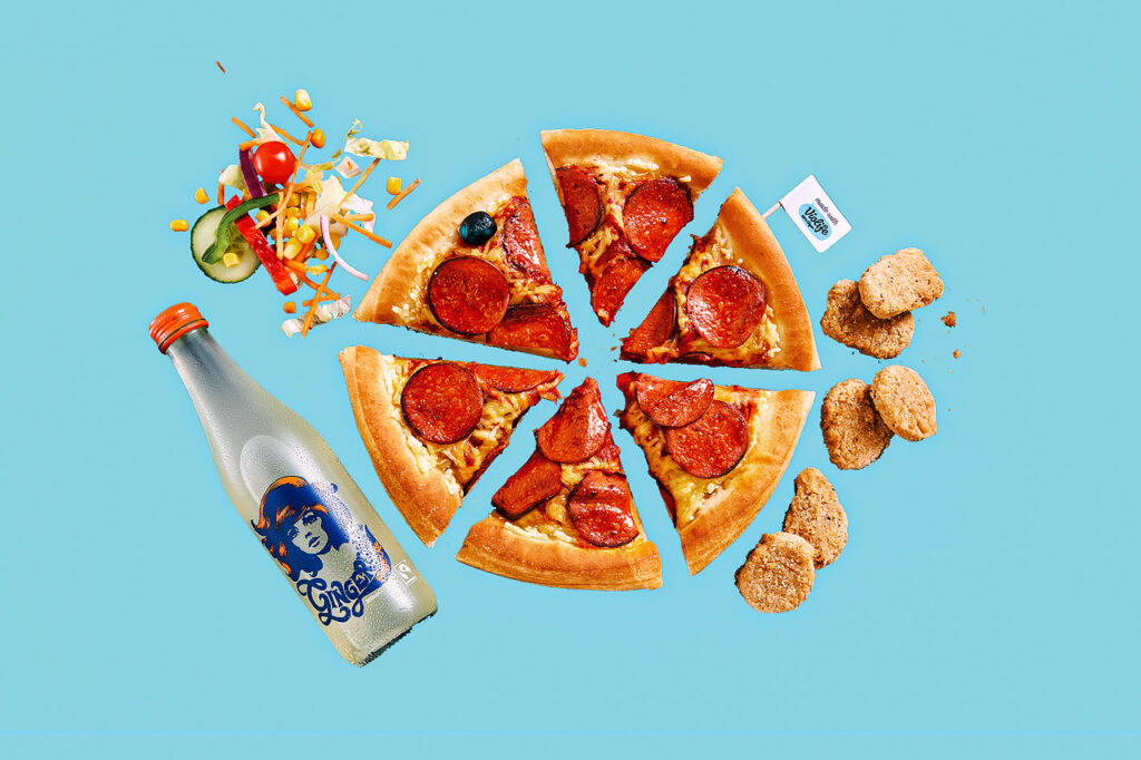Collage of several Pizza Hut vegan menu items included in this guide, including pepperoni pizza, chicken nuggets, salad, and drink, on a pale blue background.
