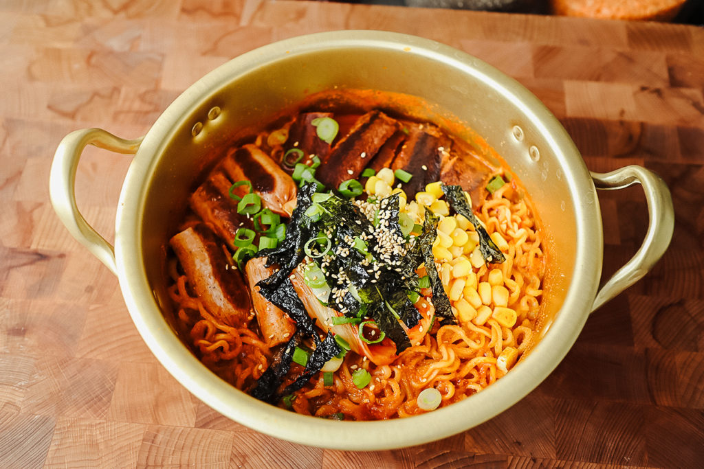 This spicy vegan Korean ramen features plant-based bacon and sausage. | Christina Ng/LIVEKINDLY
