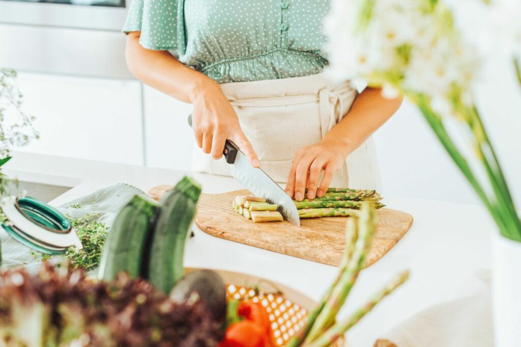 a person chopping up asparagus