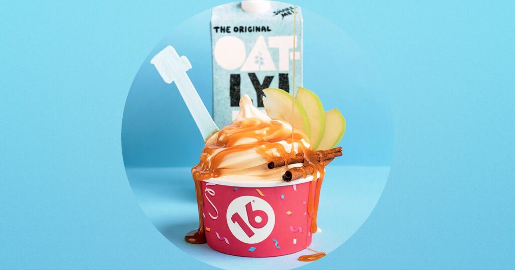 Oatly's new fall soft serve in front of an oatly carton on a blue background