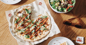 Photo of MOD Pizza's pie, now available with vegan-friendly cheese and Italian sausage.
