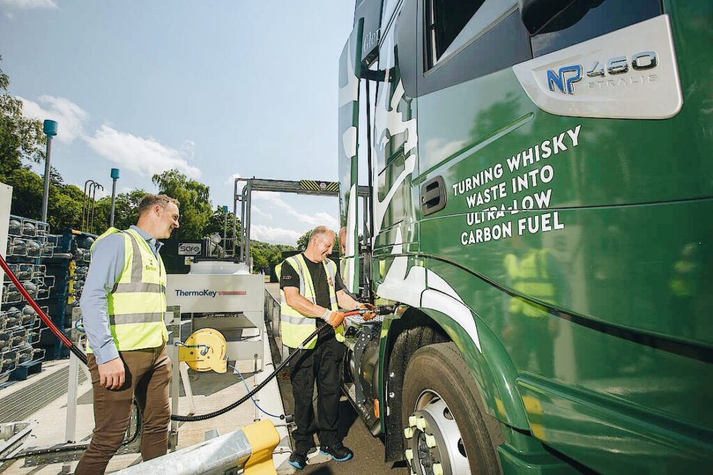 Photo of Glenfiddich workers fueling a sustainable truck.