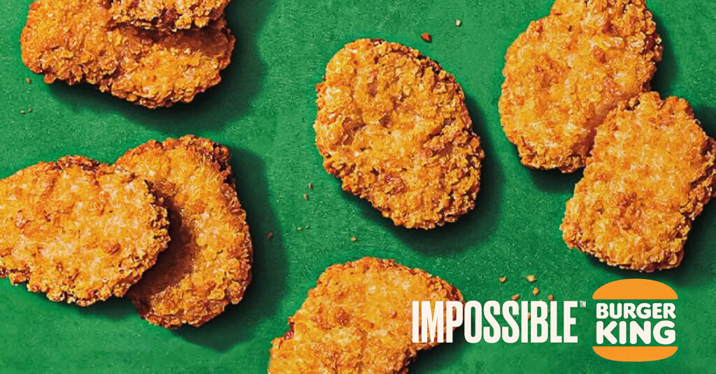 Photo shows Impossible Foods' vegan chicken nuggets on a green background next to the Impossible and Burger King logos.