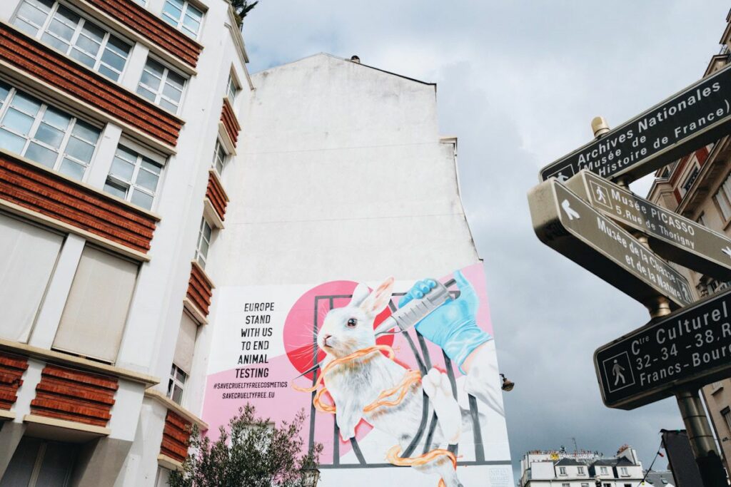 A wall mural of a bunny being injected with the words "Europe stand with us to end animal testing."