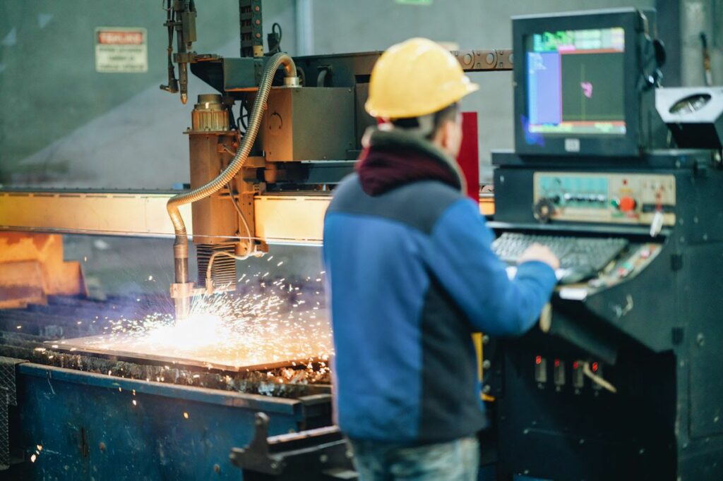 A worker produces steel in a factory