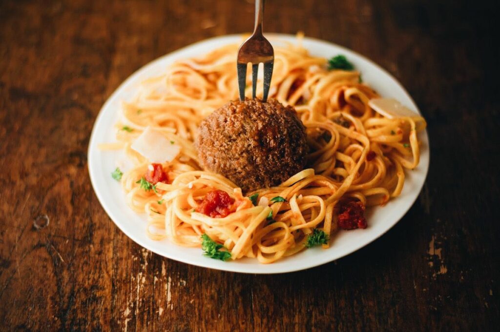a cultured meat meatball with spaghetti