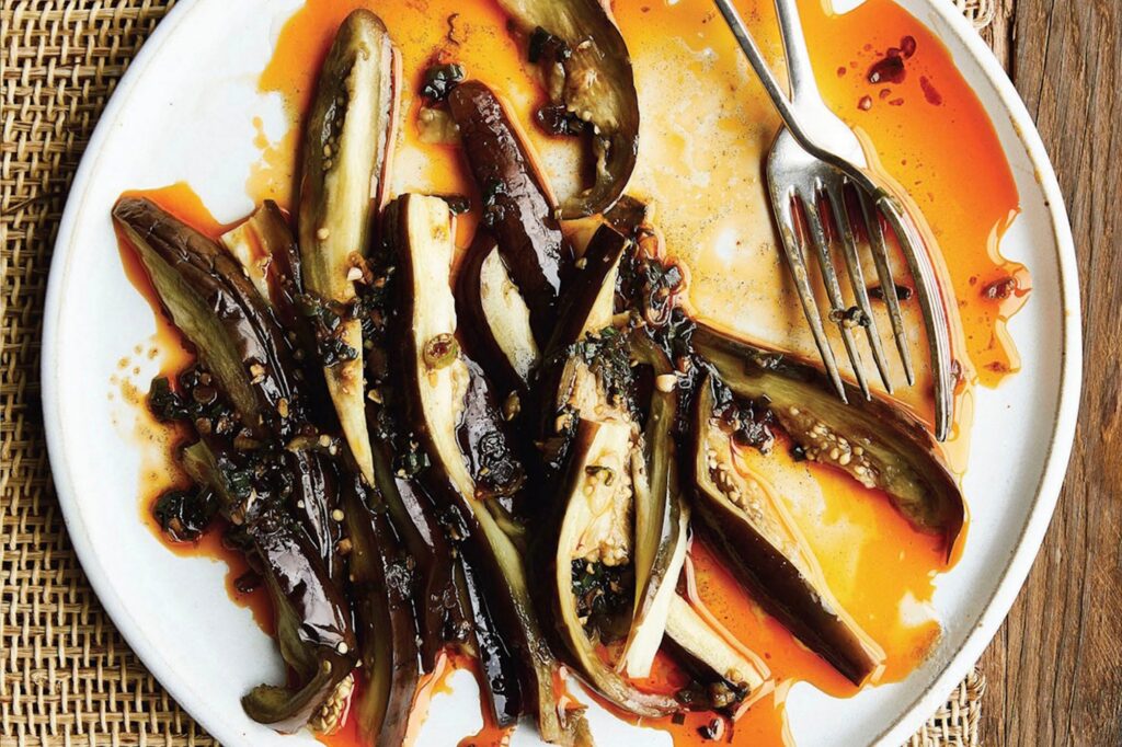 Photo shows thinly sliced eggplant served in green chili oil