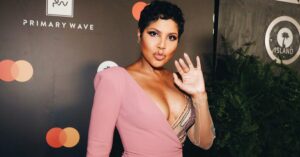 Toni Braxton in one-sleeved pink dress