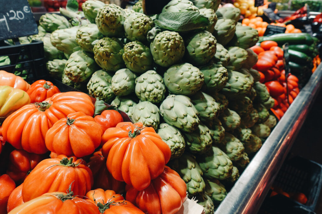 Photo shows a colorful display of vegetables at a market in Barcelona, Spain.