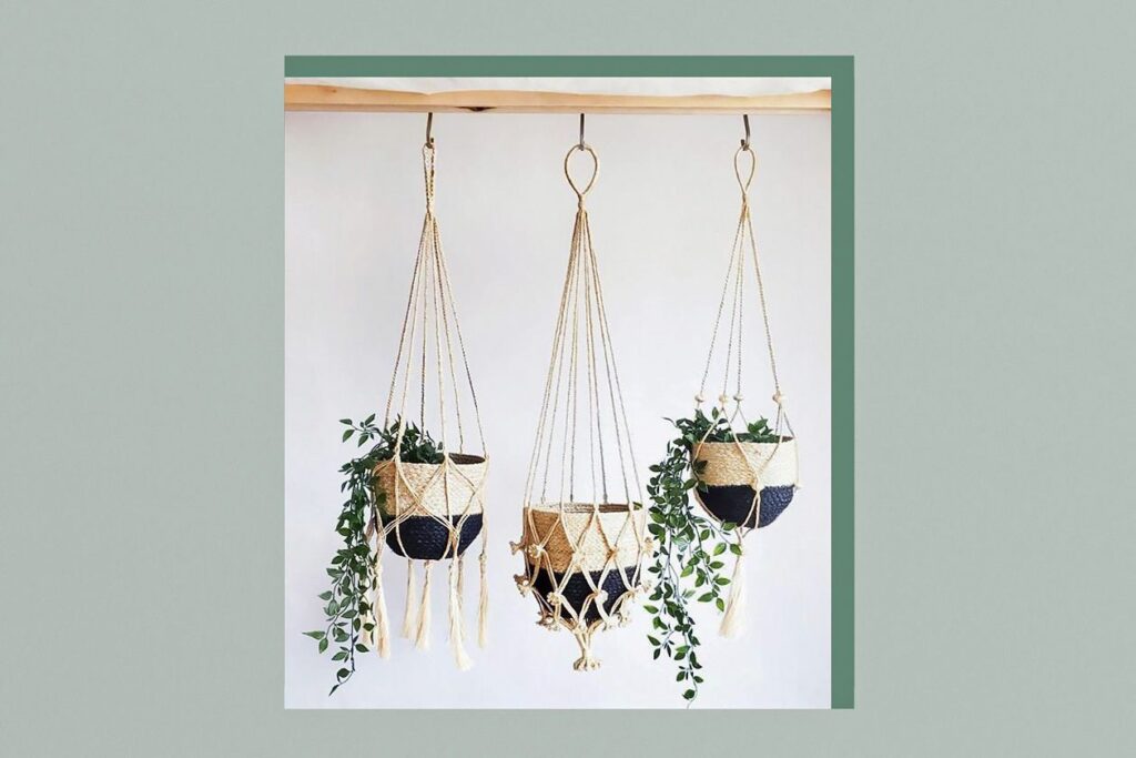 Photo shows 3 macramé hangers with tan-and-black jute baskets inside them