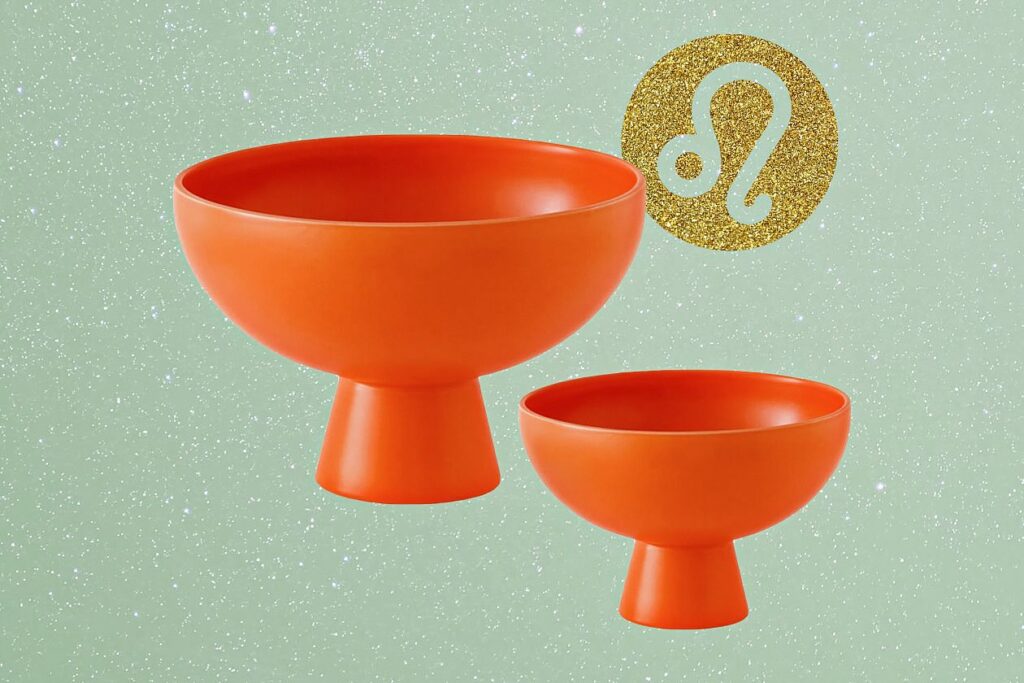 Photo shows two sculptural orange bowls