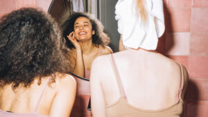 Photo shows two women doing their makeup in a mirror. Can zero-waste skincare save the beauty industry from its plastic problem?