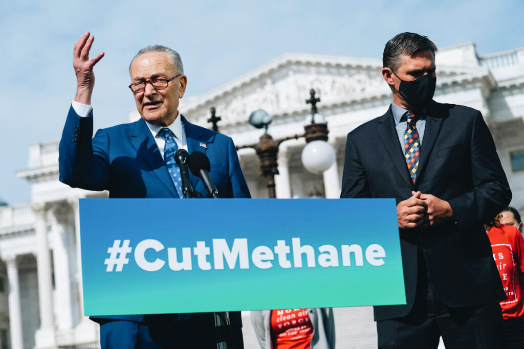 Photo shows U.S. Senate Majority Leader Chuck Schumer (D-NY) (left), with Senator Martin Heinrich (D-NM) (right), standing behind a banner that reads: "#cutmethane."
