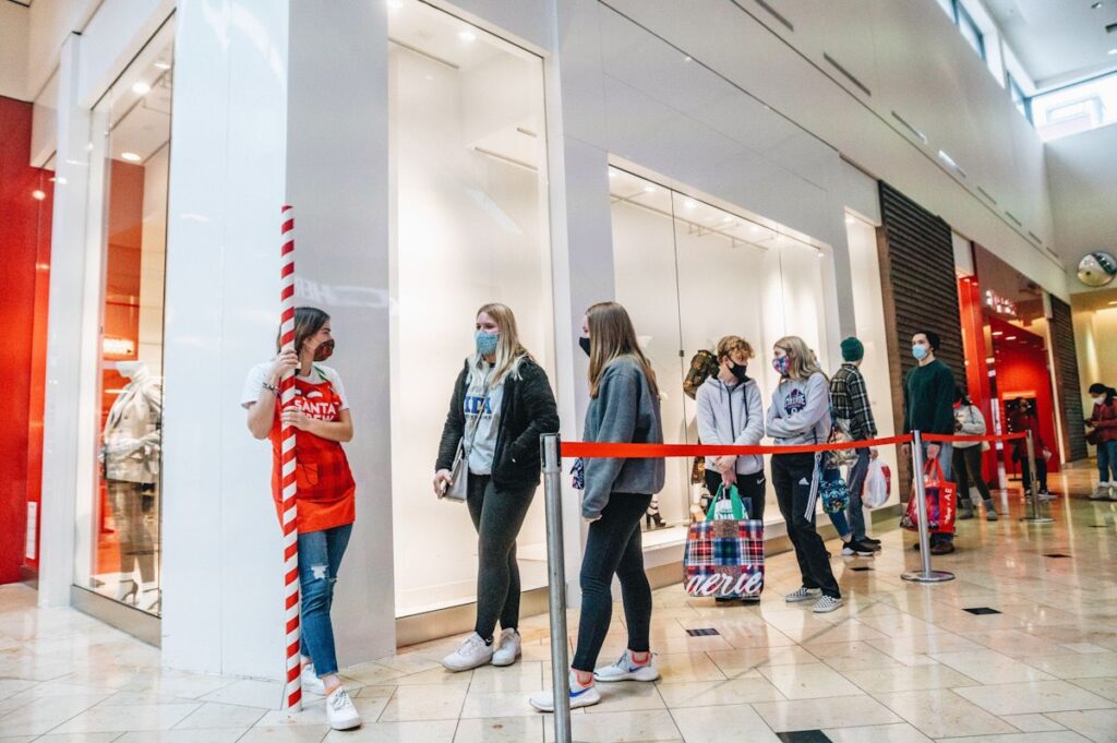 Holiday shoppers queue outside Bath & Body Works at the mall