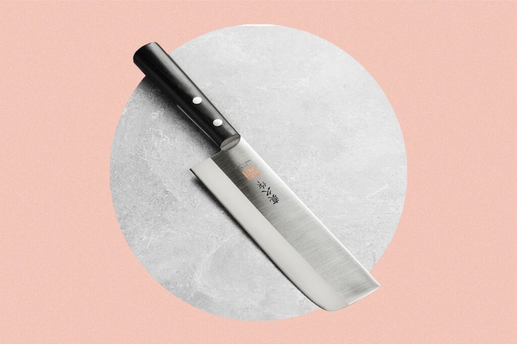 a nakiri knife against a pink background