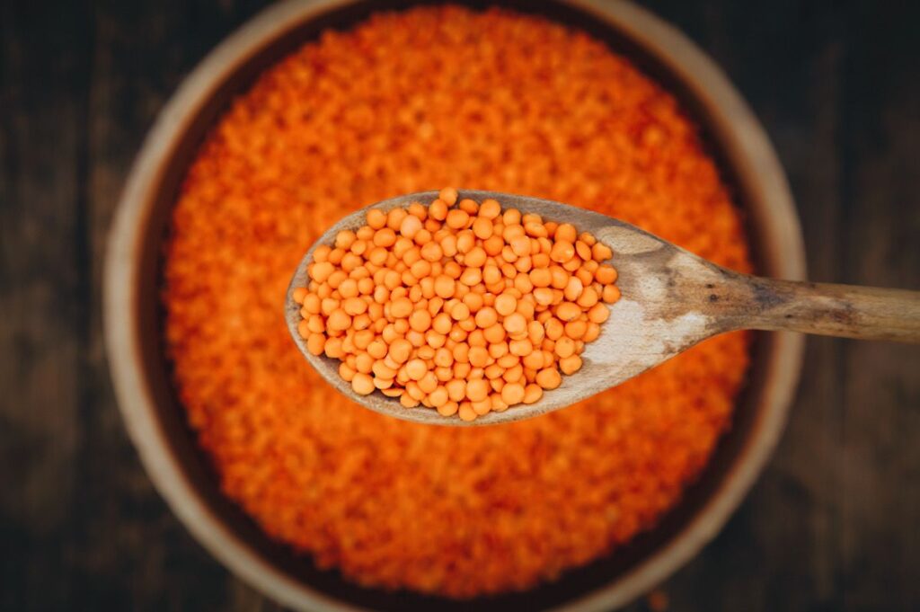 Photo shows a bowl of uncooked red lentils