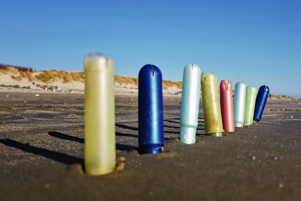 Photo shows tampon applicators discarded on a beach
