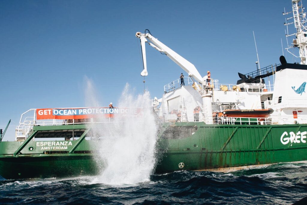 Photo shows Greenpeace dropping granite boulders into the English channel to prevent bottom trawling in MPAs.
