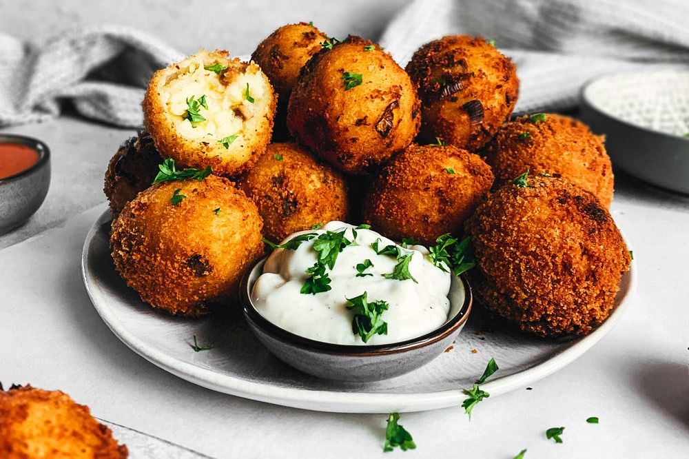 Photo shows fried potato bowls served alongside a creamy dip