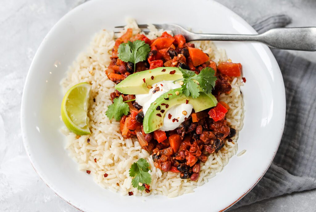 Photo shows vegan three-bean chili, a plant-based recipe suitable for the Super Bowl (or any other occasion.)