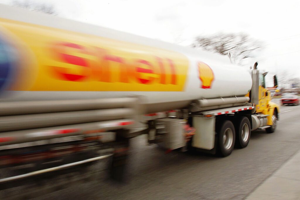 Photo shows a Shell lorry speeding past in a blur. Shell is now facing another environmental lawsuit due to its lack of action on climate change.