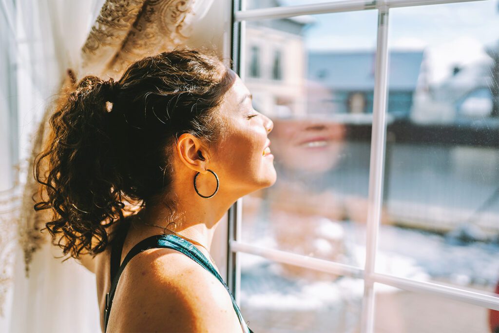 woman staring out window